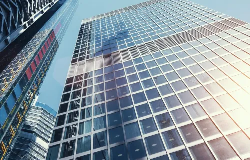 Upwards view on sun reflecting off skyscraper