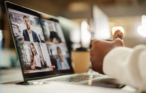 A person participating in a virtual meeting on a computer screen