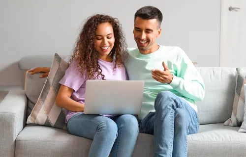 couple couch sharing computer