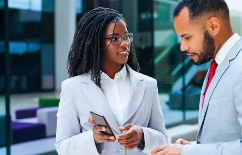 man and woman looking at phone