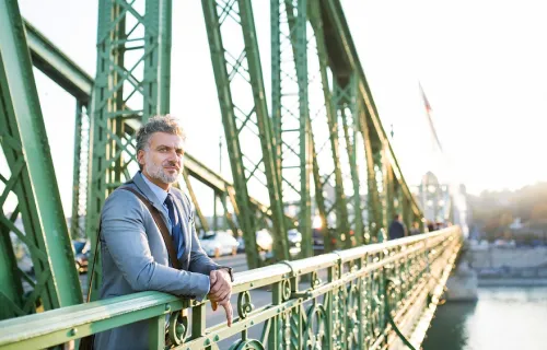man waiting on a bridge