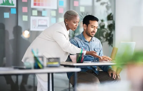 man and women looking at a laptop