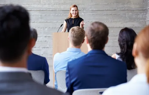 Woman gives presentation to group of people