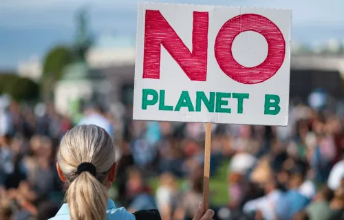woman holding no planet b placard