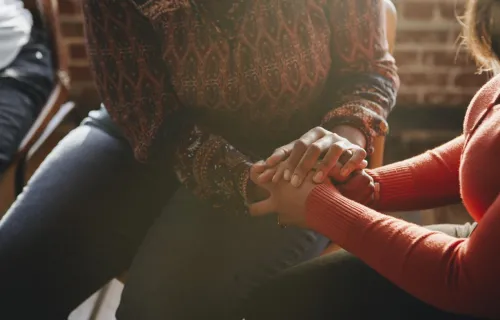 Women supporting each other holding hands