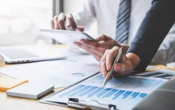 A close-up of a person and person using a tablet