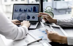 business professionals looking at data on a computer