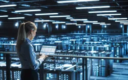 Data center IT specialist uses laptop computer