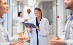 Female doctor using tablet device