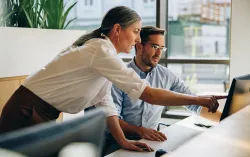 Cyber security professionals looking at monitor