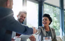 Business people shaking hands in the office for a deal.