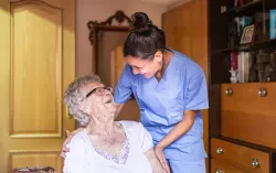 Care giver talks to elderly patient and gives support