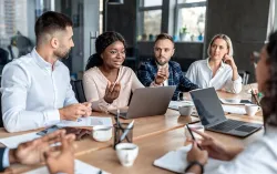 CGI Payroll consultants talk around table