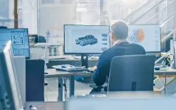 Technisches Entwicklungsumfeld für KI-Use-Cases in der Automobilindustrie mit digitalen Fahrzeugmodellen auf mehreren Bildschirmen