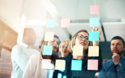 Digital transformation consultant stick sticky note to kanban board