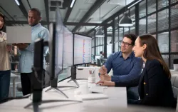 four team members working on devices