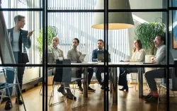 Professionals in a meeting discussing agile techniques