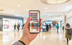 Hand holding smart phone with AR application to check information