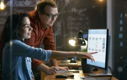 Human Centred Designers look at user experience designs on desk top computer