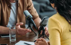 Two people recording their conversation through microphones