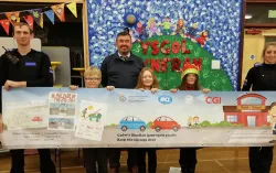 Children and police officers holding a banner