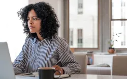 Consultant uses laptop to access machine learning to predict cracks in steel