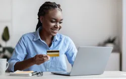Person holding credit card and making online payment