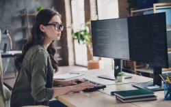 Professional working in two monitors