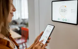 Woman looking at smart meter in home 