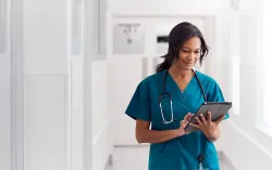 Female doctor using tablet device
