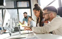 Transformation consultants looking at a computer together