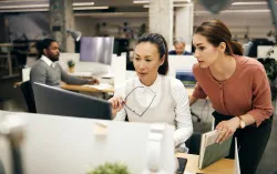 	two-businesswomen-working-on-desktop-hero