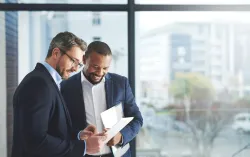 Two consultants discussing on a tablet