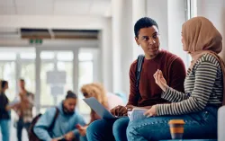 University students chatting in corridor