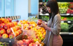 Woman looking at fruit in supermarket