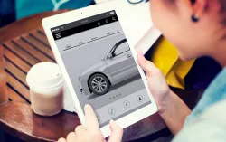 Woman looks a car on tablet