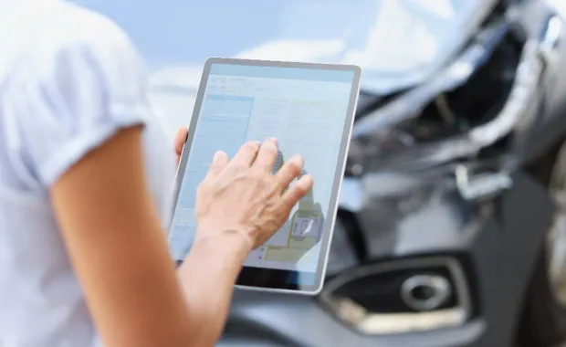 adjuster using tablet at accident site