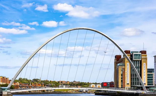 The Gateshead Millennium Bridge, a large white arch pedestrian and cycle bridge spanning the River Tyne