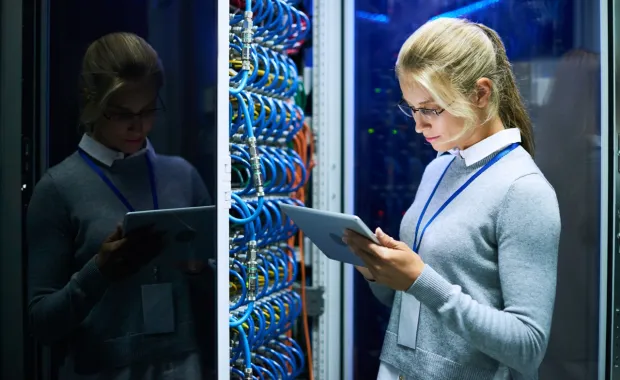 Woman checking data on digital tablet