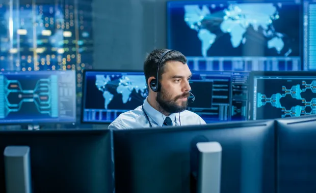 System control room dispatcher talks into headset System control room dispatcher talks into headset