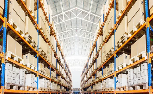 Rows of shelves with boxes in modern warehouse