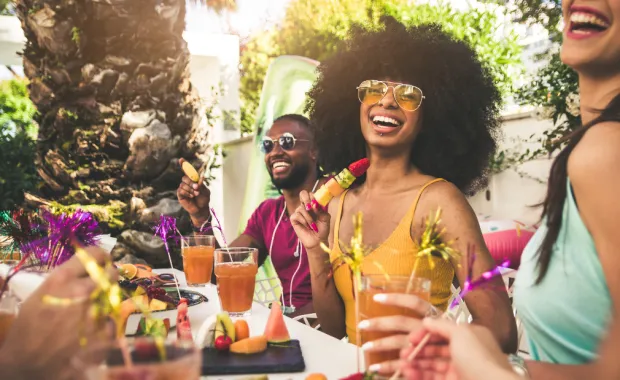 Happy woman smiling at the camera having fun with friends outdoors