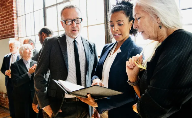 Woman and men looking for folder_340500248