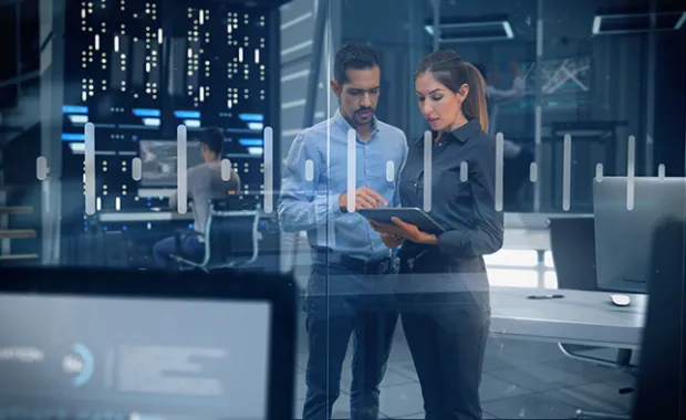 Female and Male Engineers Analyzing Data on Futuristic Transparent Touch Screen. Developers and Engineers Working in High Tech Research Lab with Data Servers using Computers showing Data and Graphs