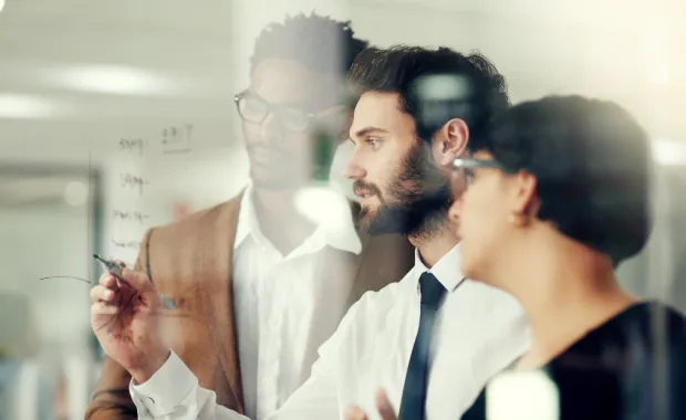 Consultants working on whiteboard