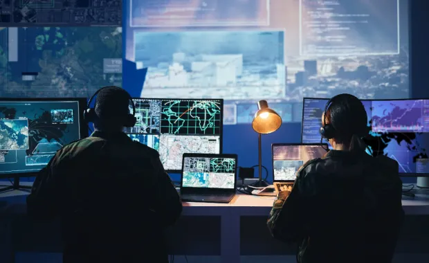 two people working in a control room
