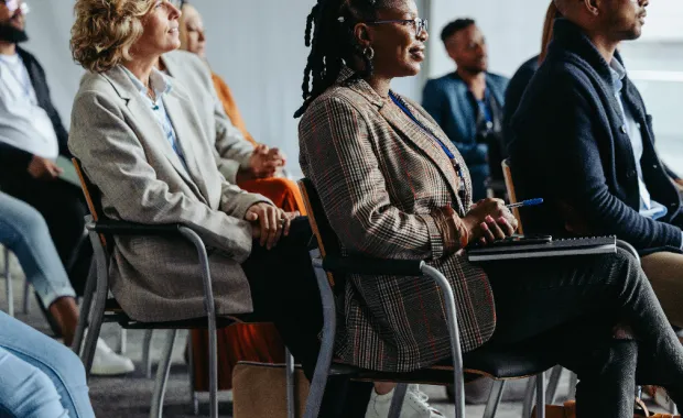 a group of people sat in chairs watching a presentation