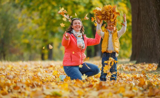 Woman and a child have fun in autumn