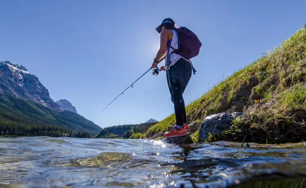 person fishing at a river in Alberta, Canada