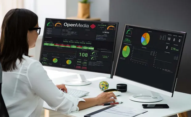 administrator analyzing OpenMedia metrics on monitor